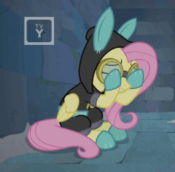 Size: 473x464 | Tagged: safe, screencap, fluttershy, pony, g4, season 9, sparkle's seven, animated, bunny ears, claustrophobia, clothes, costume, dangerous mission outfit, female, gif, goggles, hoodie, scared, solo, tv rating, tv-y