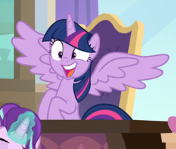 Size: 741x624 | Tagged: safe, screencap, starlight glimmer, twilight sparkle, alicorn, pony, unicorn, sparkle's seven, cropped, desk, excited, faic, female, gasp, glowing horn, horn, magic, mare, offscreen character, open mouth, sitting, solo focus, spread wings, twilight sparkle (alicorn), wide eyes, wings