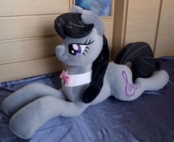 Size: 3152x2554 | Tagged: safe, artist:adamar44, octavia melody, earth pony, pony, g4, bed, bowtie, female, high res, irl, lidded eyes, mare, photo, plushie, smiling