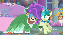 Size: 1366x768 | Tagged: safe, screencap, sandbar, yona, earth pony, pony, yak, g4, she's all yak, alternate hairstyle, blushing, bowl, bowtie, bucket, clothes, cloven hooves, cup, dress, duo, ear piercing, earring, eyeshadow, female, food, jewelry, lemon, makeup, male, pearl earrings, piercing, punch (drink), punch bowl, teenager, wig
