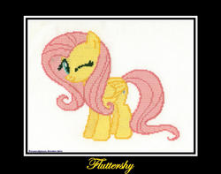 Size: 900x708 | Tagged: safe, artist:peruserofpieces, fluttershy, pegasus, pony, g4, cross stitch, one eye closed, photo, simple background, smiling, wings, wink