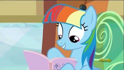 Size: 1280x720 | Tagged: safe, screencap, rainbow dash, pegasus, pony, g4, the lost treasure of griffonstone, alternate hairstyle, book, discovery family logo, fake smile, female, hoof hold, imitation, looking down, manebow sparkle, manual, multicolored mane, reading, smiling, solo, train