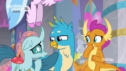 Size: 1280x720 | Tagged: safe, screencap, gallus, ocellus, silverstream, smolder, changedling, changeling, classical hippogriff, dragon, griffon, hippogriff, g4, she's all yak, amused, claws, curved horn, dragoness, female, folded wings, grin, hand over mouth, hooves, horn, horns, looking at each other, male, raised hoof, slit pupils, smiling, squint, stifling laughter, teenaged dragon, teenager, trio, unshorn fetlocks, wings