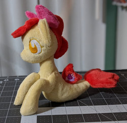 Size: 2148x2083 | Tagged: safe, artist:plushbyanto, apple bloom, seapony (g4), g4, beanie (plushie), bow, chibi, female, filly, fins, high res, irl, lying down, no mouth, no nose, no pupils, photo, plushie, profile, race swap, seaponified, seapony apple bloom, solo, species swap, tail fin, toy