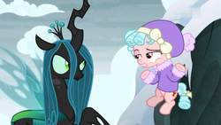 Size: 1920x1080 | Tagged: safe, screencap, cozy glow, queen chrysalis, changeling, changeling queen, pegasus, pony, frenemies (episode), g4, my little pony: friendship is magic, clothes, duo, female, filly, flying, foal, hat, shrug, snow, winter outfit