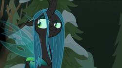Size: 1136x640 | Tagged: safe, screencap, queen chrysalis, changeling, changeling queen, frenemies (episode), g4, female, looking back, smug, snow, solo, tree