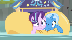 Size: 1920x1080 | Tagged: safe, screencap, starlight glimmer, trixie, pony, unicorn, g4, road to friendship, cheek squish, cheek to cheek, female, friendshipping, ghastly gorge, i guess we're stuck together, inflatable, inflatable raft, mare, one eye closed, prone, raft, river, squished, squishy cheeks, trixie's wagon, wagon, we're friendship bound