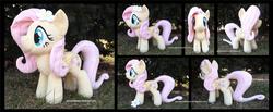 Size: 4275x1754 | Tagged: safe, artist:peruserofpieces, fluttershy, pegasus, pony, g4, accessory, female, flower, flower in hair, folded wings, front view, happy, irl, long tail, mare, photo, plushie, profile, smiling, solo, toy, wings