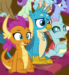 Size: 613x670 | Tagged: safe, screencap, clever musings, cozy glow, gallus, november rain, ocellus, smolder, violet twirl, changedling, changeling, dragon, griffon, pegasus, pony, unicorn, a matter of principals, chest feathers, chest fluff, classroom, claws, cropped, curly hair, curved horn, cute, diaocelles, dragoness, eager, excited, fangs, female, filly, folded wings, friendship student, gallabetes, horn, horns, male, notebook, open mouth, pencil, pencil in mouth, school of friendship, sitting, slit pupils, smolderbetes, talons, teenaged dragon, teenager, wings