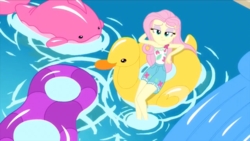 Size: 1280x720 | Tagged: safe, fluttershy, equestria girls, equestria girls series, g4, i'm on a yacht, spoiler:eqg series (season 2), clothes, female, floaty, inflatable, lidded eyes, looking at you, pool toy, shorts, smiling, solo, swimming pool