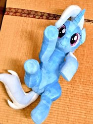 Size: 768x1024 | Tagged: safe, artist:nekokevin, trixie, pony, unicorn, g4, cute, diatrixes, female, irl, looking at you, lying down, mare, on back, photo, plushie, raised hoof, smiling, solo, underhoof