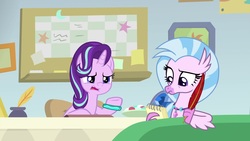Size: 1920x1080 | Tagged: safe, screencap, silverstream, starlight glimmer, classical hippogriff, hippogriff, pony, unicorn, g4, student counsel, beak, bracelet, claws, desk, duo, female, frown, guidance counselor, inkwell, jewelry, looking down, mare, notepad, open mouth, quill, raised eyebrow, raised hoof, starlight's office, talking, talons, teacher and student, teenager