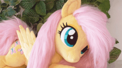 Size: 634x356 | Tagged: safe, artist:epicrainbowcrafts, artist:iisaw, fluttershy, pegasus, pony, g4, animated, blinking, cute, female, fluffy, folded wings, gif, irl, mare, photo, plushie, prone, shyabetes, smiling, solo, wings