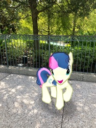 Size: 3024x4032 | Tagged: safe, gameloft, photographer:undeadponysoldier, bon bon, sweetie drops, earth pony, pony, g4, augmented reality, bush, disney springs, disney world, downtown disney, female, irl, looking at you, mare, open mouth, photo, ponies in real life, solo, tree