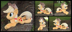 Size: 1338x597 | Tagged: safe, artist:peruserofpieces, applejack, earth pony, pony, g4, accessory, beanie (plushie), cowboy hat, female, front view, happy, hat, irl, lying down, mare, photo, plushie, profile, prone, smiling, solo, sploot, toy