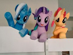 Size: 1024x768 | Tagged: safe, artist:nekokevin, starlight glimmer, sunset shimmer, trixie, pony, unicorn, series:nekokevin's glimmy, g4, crossed hooves, female, irl, looking at you, magical trio, mare, open mouth, photo, plushie, raised hoof, smiling, trio, underhoof