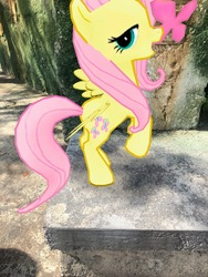 Size: 3024x4032 | Tagged: safe, gameloft, photographer:undeadponysoldier, fluttershy, butterfly, pegasus, pony, g4, animal kingdom, augmented reality, disney world, female, florida, irl, looking at you, mare, open mouth, orlando, photo, ponies in real life, pose, standing up
