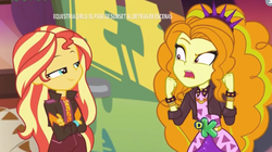 Size: 537x300 | Tagged: safe, screencap, adagio dazzle, sunset shimmer, equestria girls, equestria girls specials, g4, my little pony equestria girls: better together, my little pony equestria girls: sunset's backstage pass, crossed arms, discovery kids, smugset shimmer, spanish, spiked headband