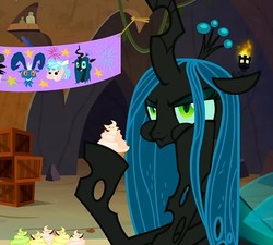 Size: 697x626 | Tagged: safe, screencap, cozy glow, grogar, lord tirek, queen chrysalis, changeling, changeling queen, frenemies (episode), g4, annoyed, banner, cropped, cupcake, cute, cutealis, eating, female, food, puffy cheeks, solo