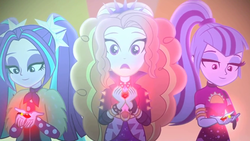 Size: 1336x752 | Tagged: safe, screencap, adagio dazzle, aria blaze, sonata dusk, equestria girls, find the magic, g4, my little pony equestria girls: better together, female, gem, looking at something, pigtails, ponytail, siren gem, smiling, taco dress, the dazzlings have returned, trio, trio female, twintails, when she smiles