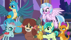 Size: 1920x1080 | Tagged: safe, screencap, gallus, ocellus, sandbar, silverstream, smolder, yona, changedling, changeling, classical hippogriff, dragon, earth pony, griffon, hippogriff, pony, yak, g4, she's all yak, best friends, bow, bowtie, claws, cloven hooves, colored hooves, crossed arms, cute, diaocelles, diastreamies, dragoness, female, flying, folded wings, gallabetes, grin, hair bow, hand on hip, horns, jewelry, male, monkey swings, necklace, raised eyebrow, sandabetes, smiling, smolderbetes, smugder, spread wings, student six, talons, teenager, trophy, wings, yonadorable
