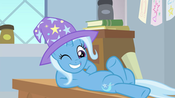 Size: 1280x720 | Tagged: safe, screencap, trixie, pony, unicorn, a horse shoe-in, g4, anatomically incorrect, arm behind head, clothes, female, grin, hat, incorrect leg anatomy, mare, misleading thumbnail, on back, one eye closed, smiling, solo, trixie's hat, wink, wizard hat