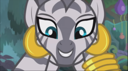Size: 1369x769 | Tagged: safe, screencap, zecora, pony, zebra, g4, she talks to angel, close-up, cropped, crouching, ear piercing, earring, female, jewelry, leg rings, looking at you, mare, piercing, smiling, solo