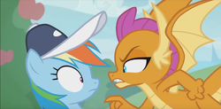 Size: 1231x606 | Tagged: safe, screencap, rainbow dash, smolder, dragon, pegasus, pony, 2 4 6 greaaat, g4, angry, claws, clenched fist, coach, coach rainbow dash, duo, fangs, female, flying, gritted teeth, hat, horns, lidded eyes, mare, pointing, shrunken pupils, smolder is not amused, spread wings, teenaged dragon, teenager, wings