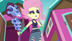 Size: 1920x1080 | Tagged: safe, screencap, fluttershy, human, equestria girls, g4, my little pony equestria girls: choose your own ending, the road less scheduled, the road less scheduled: fluttershy, choker, clothes, ear piercing, earring, eyeshadow, female, flutterpunk, goth, hand on hip, jewelry, lipstick, makeup, midriff, piercing, punk, purple lipstick, ripped pants, skull, sleeveless, smiling, staff, tank top