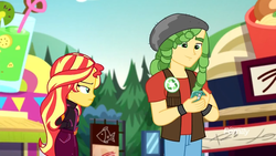 Size: 1280x720 | Tagged: safe, screencap, sandalwood, sunset shimmer, equestria girls, equestria girls specials, g4, my little pony equestria girls: better together, my little pony equestria girls: sunset's backstage pass, cellphone, clothes, female, geode of empathy, hand in pocket, jacket, magical geodes, male, music festival outfit, phone, smartphone, smiling