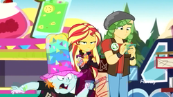 Size: 1280x720 | Tagged: safe, screencap, sandalwood, snips, sunset shimmer, equestria girls, equestria girls specials, g4, my little pony equestria girls: better together, my little pony equestria girls: sunset's backstage pass, clothes, crossed arms, discovery family logo, hat, jacket, male, music festival outfit, pants, shrunken pupils