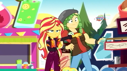 Size: 1280x720 | Tagged: safe, screencap, sandalwood, sunset shimmer, equestria girls, equestria girls specials, g4, my little pony equestria girls: better together, my little pony equestria girls: sunset's backstage pass, cellphone, clothes, discovery family logo, female, male, music festival outfit, pants, phone, smartphone