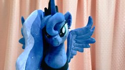 Size: 1024x577 | Tagged: safe, artist:nekokevin, princess luna, alicorn, pony, g4, female, irl, jewelry, looking at you, mare, peytral, photo, plushie, regalia, smiling, solo, spread wings, wings