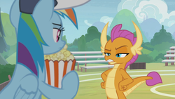 Size: 1366x768 | Tagged: safe, screencap, rainbow dash, smolder, dragon, pegasus, pony, 2 4 6 greaaat, g4, bleachers, coach rainbow dash, coaching cap, displeased, dragoness, fangs, female, fence, field, flag, folded wings, food, glare, hand on hip, hat, horns, looking at each other, mare, multicolored mane, narrowed eyes, popcorn, raised eyebrow, smolder is not amused, teacher and student, teenaged dragon, teenager, unamused