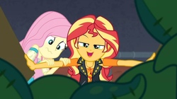 Size: 953x534 | Tagged: safe, screencap, fluttershy, sunset shimmer, costume conundrum, costume conundrum: sunset shimmer, equestria girls, g4, my little pony equestria girls: better together, female, geode of empathy, looking at you, magical geodes, scared, she knows