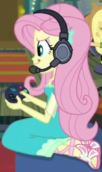 Size: 331x554 | Tagged: safe, screencap, applejack, fluttershy, costume conundrum, equestria girls, g4, my little pony equestria girls: better together, controller, cropped, cute, feet, female, fluttershy boho dress, gamer fluttershy, geode of fauna, headphones, headset, headset mic, magical geodes, offscreen character, sandals, sitting, solo focus, tongue out