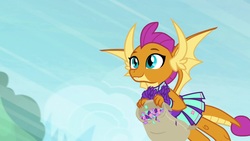 Size: 1920x1080 | Tagged: safe, screencap, smolder, dragon, 2 4 6 greaaat, g4, bag, cheerleader outfit, cheerleader smolder, claws, clothes, confetti, cute, dragoness, fangs, female, flying, horns, smiling, smolderbetes, solo, spread wings, wings