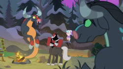 Size: 1920x1080 | Tagged: safe, screencap, cozy glow, lord tirek, queen chrysalis, centaur, ophiotaurus, pegasus, pony, frenemies (episode), g4, campfire, clothes, cloven hooves, disguise, disguised changeling, female, filly, flying, foal, forest, hat, log, male, nose piercing, nose ring, open mouth, piercing, pine tree, septum piercing, tree, tree stump, winter outfit