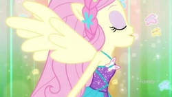 Size: 2048x1152 | Tagged: safe, screencap, fluttershy, butterfly, cheer you on, equestria girls, g4, my little pony equestria girls: better together, bare shoulders, clothes, discovery family logo, dress, eyes closed, female, flower, flower in hair, geode of fauna, green background, halterneck, magical geodes, open mouth, open smile, ponied up, simple background, sleeveless, smiling, solo, super ponied up, wings