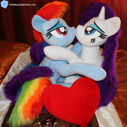 Size: 1848x1848 | Tagged: safe, artist:ponimalion, rainbow dash, rarity, pegasus, pony, unicorn, g4, bed, bedroom, bedroom eyes, duo, duo female, female, heart, heart pillow, horn, hug, irl, kissing, lesbian, life size, mare, photo, pillow, plushie, ship:raridash, shipping, sitting, tail wrap, wings