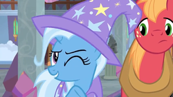 Size: 1600x900 | Tagged: safe, screencap, big macintosh, trixie, earth pony, pony, unicorn, a horse shoe-in, g4, cape, clothes, column, female, hat, male, mare, one eye closed, stallion, trixie's cape, trixie's hat, wink