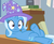 Size: 1189x980 | Tagged: safe, screencap, trixie, pony, unicorn, a horse shoe-in, g4, anatomically incorrect, classroom, clothes, cropped, crossed legs, desk, discovery family logo, female, hat, incorrect leg anatomy, interrupted, mare, on back, reclining, shrunken pupils, solo, surprised, trixie's hat, wide eyes