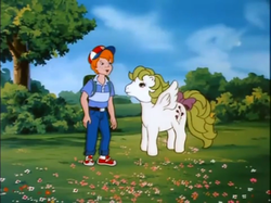 Size: 771x577 | Tagged: safe, screencap, danny williams, surprise, g1, my little pony 'n friends, the great rainbow caper, adoraprise, backpack, baseball cap, bow, cap, cute, dannybetes, hat, tail bow, tree