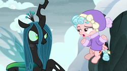 Size: 1280x720 | Tagged: safe, screencap, cozy glow, queen chrysalis, frenemies (episode), g4, bickering, clothes, cozy glow is not amused, crown, female, filly, flapping, flying, foal, former queen chrysalis, freckles, glare, insect wings, jacket, jewelry, lidded eyes, raised eyebrow, raised hoof, regalia, shrug, snow, spread wings, wings, winter outfit