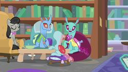 Size: 1280x720 | Tagged: safe, screencap, carapace (g4), ocellus, octavia melody, spiracle, changedling, changeling, earth pony, pony, a horse shoe-in, g4, animation error, book, bookshelf, bowtie, eyes closed, female, library, mare, sitting, wat