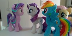 Size: 2048x1024 | Tagged: safe, artist:nekokevin, fluttershy, rainbow dash, rarity, starlight glimmer, pegasus, pony, unicorn, series:nekokevin's glimmy, g4, female, irl, looking at each other, mare, photo, plushie, shrunken pupils, smiling, spread wings, wings