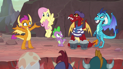 Size: 1280x720 | Tagged: safe, screencap, baby rubble, baby sparks, fluttershy, garble, princess ember, smolder, spike, dragon, pegasus, pony, g4, sweet and smoky, beatnik, bongos, dragoness, female, male, mare, musical instrument, teenaged dragon, winged spike, wings
