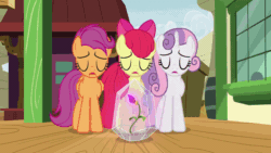 Size: 800x450 | Tagged: safe, screencap, apple bloom, scootaloo, sweetie belle, earth pony, pegasus, pony, unicorn, g4, growing up is hard to do, age regression, age spell, animated, apple bloom's bow, bow, crystal, eyes closed, female, flower, gif, hair bow, magic, magic flower, magic glow, older, older apple bloom, older cmc, older scootaloo, older sweetie belle, train station, wings, wish, wishing flower