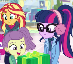 Size: 755x658 | Tagged: safe, screencap, lily pad (g4), little red, sci-twi, sunset shimmer, twilight sparkle, equestria girls, equestria girls series, g4, holidays unwrapped, spoiler:eqg series (season 2), canterlot mall, child, clothes, coat, cropped, cute, earmuffs, female, gift giving, happy, offscreen character, ponytail, smiling, winter outfit