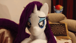 Size: 600x338 | Tagged: safe, artist:ponimalion, rainbow dash, rarity, g4, animated, bed, bedroom eyes, duo, duo female, female, heart, heart pillow, irl, jumping, lesbian, life size, photo, pillow, plushie, ship:raridash, shipping, youtube, youtube link